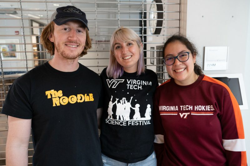 Three student volunteers at the Kids' Tech University.