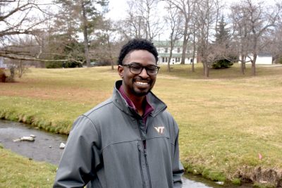 Austin Gray stands in front of a creek