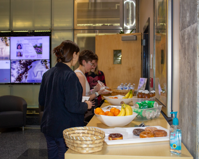 Group of individuals near a food table for the Fralin Fridays gathering sponsored by the Fralin Life Sciences Institute. 
