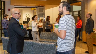 A gathering of people standing talking to each other for Fralin Fridays hosted by the Fralin Life Sciences Institute.