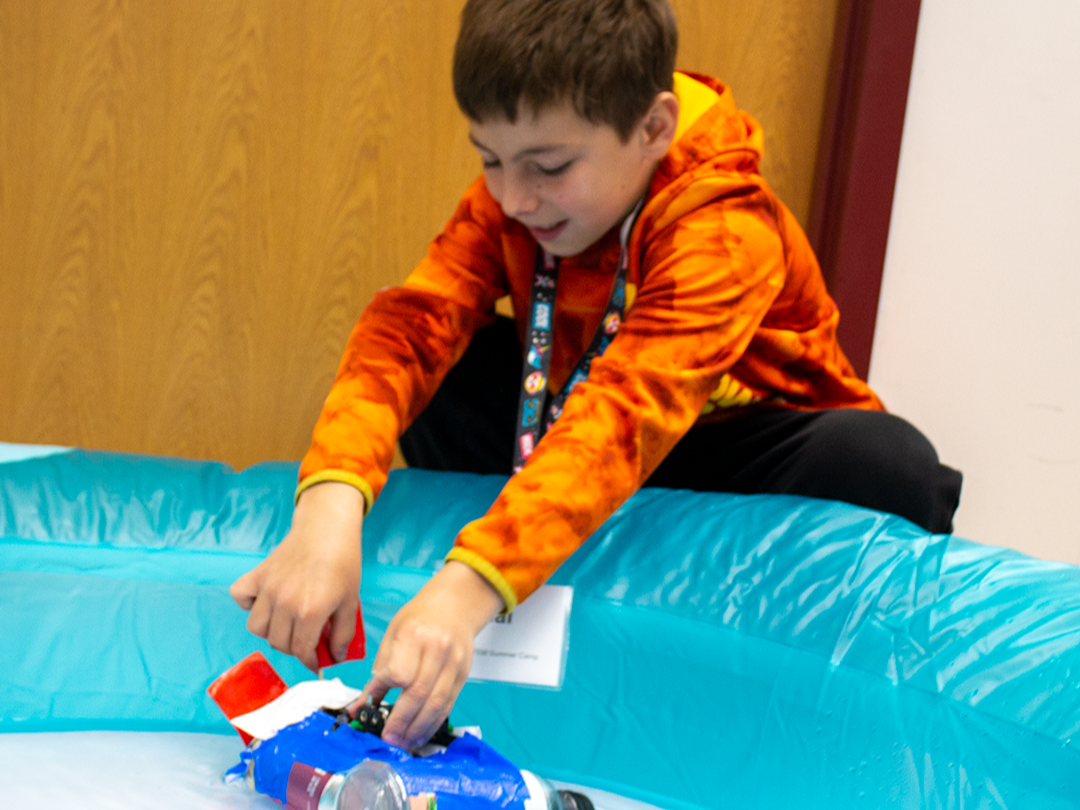 A young student with a STEM activity at summer camp.
