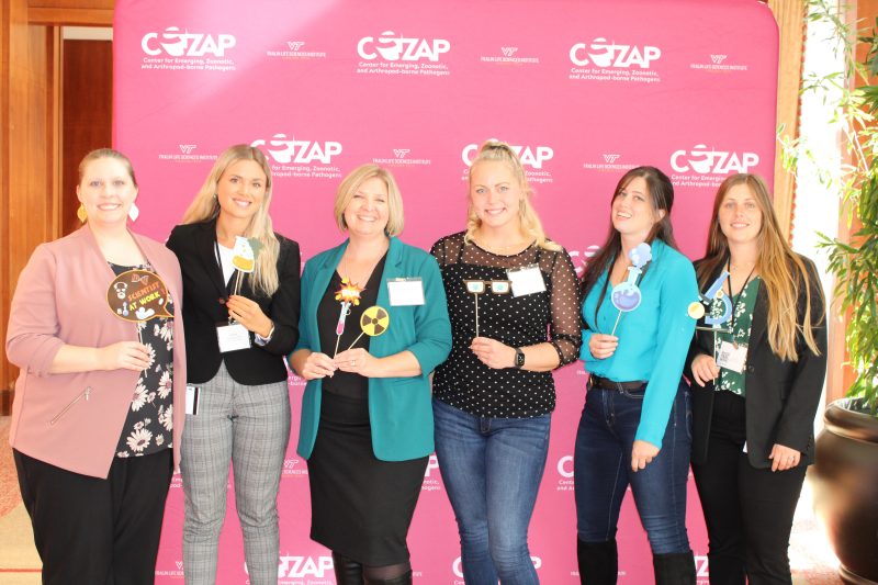 Morgen VanderGiessen with members of her lab team at the Center for Emerging, Zoonotic, and Arthropod-borne Pathogens annual symposium photo booth.