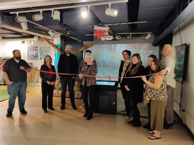 Dorothea Tholl cuts the ribbon on opening day of the "What's That Your [Say] Smell?" exhibit, now in permanent residence at the Science Museum of Western Virginia in Roanoke, along with the exhibit contributors and collaborators. Photo courtesy of Dorothea Tholl.