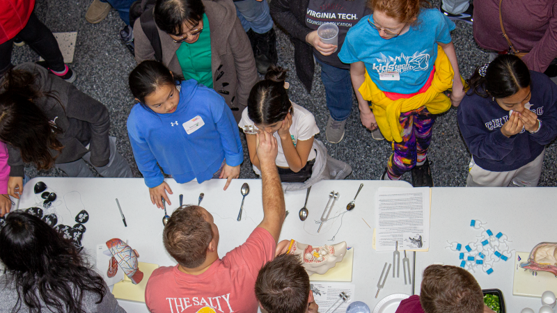 Aerial shot of presenters engaging with the Kids' Tech University participants.