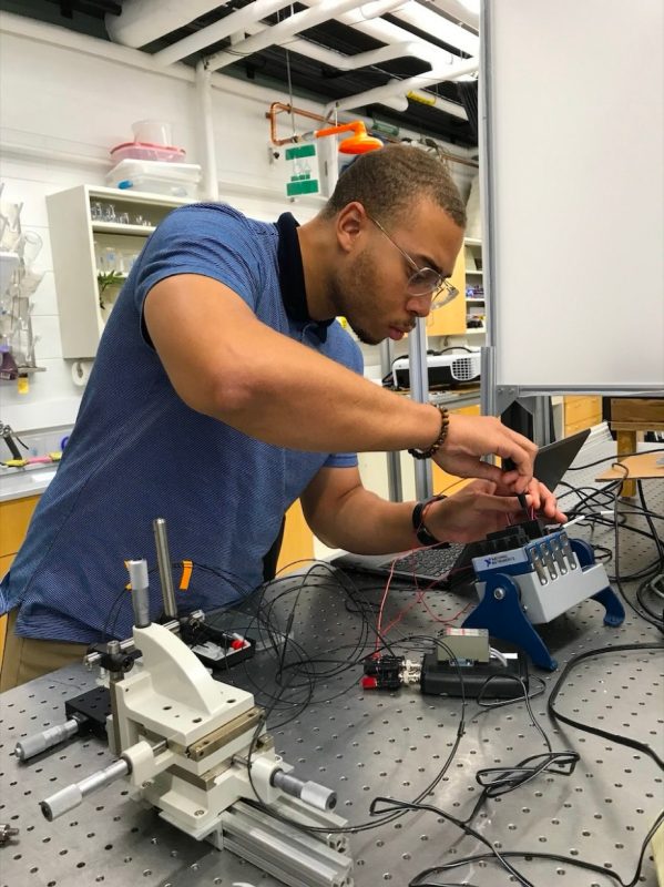 Donovan Hardy conducts insect research in lab