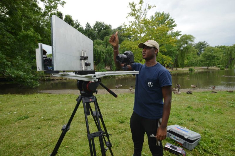 HBCU undergraduate student Ira Moore adjusts equipment to study how ducks land on water at the Duck Pond.